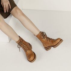 a woman in brown boots is sitting down