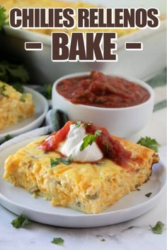 an omelet on a white plate with salsa and sour cream in the background