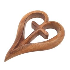 a wooden brooch with two hearts and an arrow in the shape of a heart