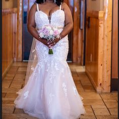 a woman in a wedding dress holding a bouquet