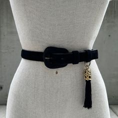 90s Points West black genuine leather belt, vtg classic black belt, coquette tassel, normcore aesthetic, maximalist sophisticated fashion Embrace the timeless allure of our 90s Points West Black Genuine Leather Belt--a vintage classic reimagined for the modern maximalist. This coquette tassel-adorned belt effortlessly embodies normcore aesthetics while exuding a sophisticated flair that transcends trends. Crafted from sumptuous suede, the texture adds a tactile dimension, elevating the belt into a piece of wearable art. The pièce de résistance is the black tassel, swaying with playful elegance, suspended from the belt by a gold-tone ornament. This subtle yet opulent detail transforms the belt into a statement piece that seamlessly blends into any maximalist fashion ensemble. The minimalist Normcore Aesthetic, Modern Maximalist, Maximalist Fashion, Sophisticated Fashion, Genuine Leather Belt, Suspender Belt, Classic Elegance, Chic Dress, Vintage Jeans