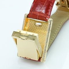 Cartier Tank Basculante Gold & Diamond WatchVintage Cartier Tank Basculante luxury dress styles watch yellow gold case and diamonds. White dial with black roman numerals. Original Cartier red leather strap with an 18k yellow gold deployant buckle. The Cartier Tank is probably the most recognizable, and symbolic rectangle watch ever to be introduced. In terms of design this accomplishment is just outstanding, and reflects the incredible capabilities of the Cartier designers. Cartier Basculant Luxury Yellow Gold Diamond Watch For Formal Occasions, Luxury Yellow Gold Watches For Formal Occasions, Luxury Diamond Watch Bands For Anniversary, Luxury Rectangular Watch Accessories, Timeless Gold Watch With Palladium Hardware, Luxury Gold Watches For Formal Occasions, Luxury Yellow Gold Watch Accessories With Rectangular Dial, Luxury Diamond Watch With Rectangular Dial For Formal Occasions, Luxury Formal Diamond Watch With Rectangular Dial