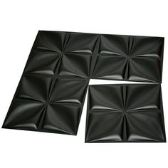 four pieces of black plastic tile on a white background