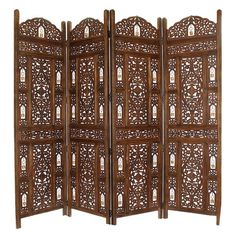 a wooden room divider with carvings on it