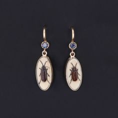 Add a touch of intrigue to any ensemble with these unique insect earrings! To create these earrings, our jeweler carefully cut antique shibayama game pieces (circa 1880) into an oval shape, mounted them in 14k gold, and added 14k ear wires and sapphire surmounts. Each earring measures 1 inch from the top of the ear wire to bottom by 0.3 inches wide, and they are in excellent condition. We have many other fantastic offerings of period fine jewelry posted on our Etsy store, so please consider brow Ear Earrings, Jewelry Post, The Ear, Antique Earrings, Sapphire Earrings, Game Pieces, Vintage Jewels, Antique Shops, Artistic Jewelry