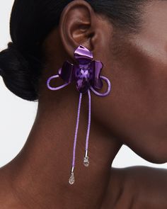 Crafted with meticulous attention to detail, The Ophelia Flower Earrings feature an abstract floral design and silk cord detail with delicate dangling crystal drops. The vibrant purple hue adds a pop of color to your ensemble, instantly elevating your style. Why You'll Love It These earrings are a true blend of elegance and playfulness, designed to make a statement wherever you go. Details Ceramic coated Silk cord Crystal Sterling silver posts Butterfly fastening and post back for pierced ears I Suede Jewelry, Abstract Floral Design, Gold Vermeil Jewelry, Vibrant Purple, Violet Flower, Silk Cord, Abstract Flower, Vermeil Jewelry, Solid Gold Jewelry