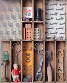 a wooden box filled with lots of different types of toys and items on top of each other