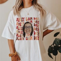 a woman wearing a t - shirt with an image of her face on it