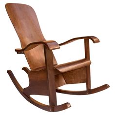 the rocking chair is made from wood and has an armrest that matches the seat