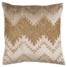 a gold and white pillow on a white background