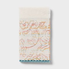 a white towel with an embroidered design on it