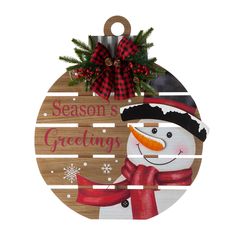 a wooden ornament with a snowman on it that says season's greeting