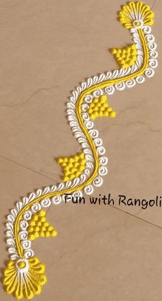 a yellow and white design on the floor with words written below it that read, fun with rangoli