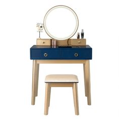 a blue vanity table with a mirror and stool