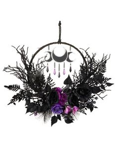 a chandelier with flowers and feathers hanging from it