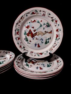 a set of four christmas plates with santa's sleigh scene on them