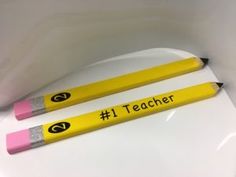 two pencils with the words i teacher written on them sitting next to each other