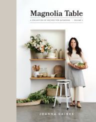 a woman standing in front of a shelf with food on it and holding a plate