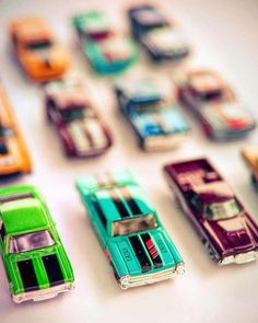 many toy cars are lined up on the table