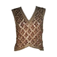 This Galanos blouse is composed of a beaded and sequin appliqued silk, in gold and burgundy hues. The top features a 3-dimensional beading technique. There are center back hook and eye closures. In excellent condition. **Please cross-reference measurements for personal accuracy. Measurements (Approximately) Length: 19" Bust: 36" Waist: 34" Clothing Blouses, Otherworldly Beauty, Vintage Blouses, Beaded Blouse, Sequin Appliques, Beading Techniques, Circular Pattern, Blouse Vintage, Hand Crochet