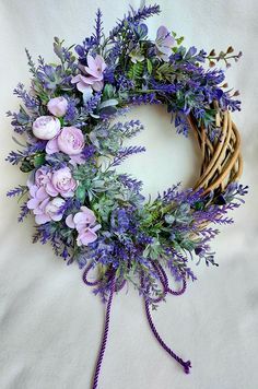 a wreath with purple flowers and greenery