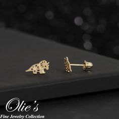 These playful Triceratops dinosaur stud earrings is the perfect addition to your children's jewelry collection. Perfect gift idea for children, daughter, granddaughter, niece, sister and friends. *Product Details* Material: 14K Gold Metal Color: Yellow Gold Earring Size: Length (5mm), Width (9.25mm) Metal Finish: Polished Post Length: 8mm long for Screw Back and 9mm for Push Back Sold in Pair (2 earrings) Occasion: Everyday use, Birthday Present, Thank You Gift, Valentine's Day, Mother's Day, Fr Dino Kids, Children's Jewelry, Dinosaur Earrings, 2 Earrings, Earring Gift, Kids Earrings, Animal Earrings, Gift For Daughter, Cute Dinosaur