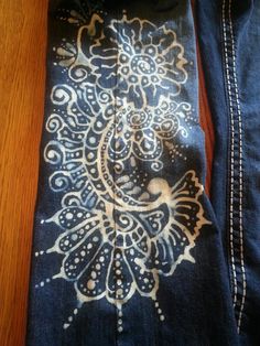 a pair of jeans with an embroidered design on them