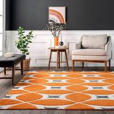 a living room with an orange and white rug on the floor next to a chair