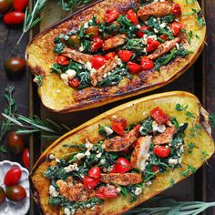 two squash halves filled with chicken, tomatoes and spinach