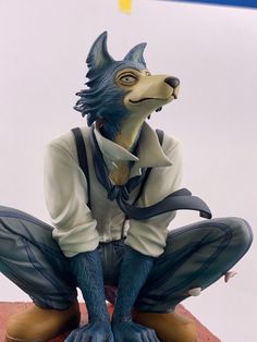 a figurine of a dog wearing a suit and tie sitting on top of a table