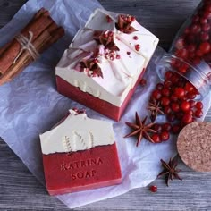 two soap bars sitting on top of paper next to cinnamons and star anise