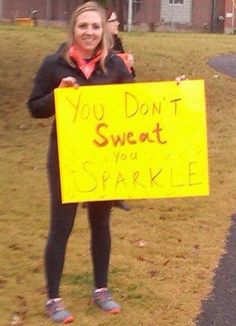 a woman holding a yellow sign that says you don't sweat if you sparkle