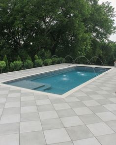 an empty swimming pool surrounded by trees