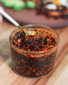 a spoon in a glass filled with food