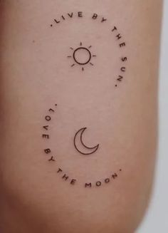 a woman's arm with the words live by the sun, love by the moon written on it