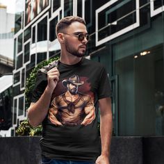 Celebrate your bold sense of style with our Alluring Muscular Cowboy Tee, tailored for those who appreciate the fusion of edginess and masculinity. This black, short-sleeve t-shirt features a striking print of a hunky, muscular cowboy, showcasing his undeniable allure and a hint of danger. Crafted from soft, high-quality materials, this tee promises comfort and durability. Stand out from the crowd and let your inner risk-taker shine with this intense, stylish t-shirt. Highlights: Striking muscul Black Short Sleeve Pre-shrunk Shirt, Black Short Sleeve Urban T-shirt, Black Urban Short Sleeve T-shirt, Black Graphic Tee With Short Sleeves, Black Short Sleeve Graphic Tee, Gay T Shirt, Cowboy Print, Risk Taker, Cowboy