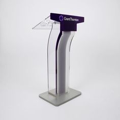 a purple and white podium with the words grant thomas on it's side, in front of a white background