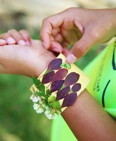 two people are holding hands with flowers on the wrist and one is wearing a yellow shirt