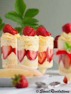 three desserts with strawberries in them on a table