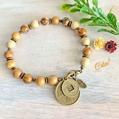 This Picture Jasper Bracelet features 9mm smooth round picture jasper aka landscape jasper gemstones. It is accented with hypoallergenic brass beads, chinese coin charms, feather charm & lobster clasp. Processing time is only 1 business day & will be gift wrapped! M O R E 🌴 GO O D I E S 🌴 H E R E https://www.etsy.com/shop/CstaJewelry Guarantee: It is my goal to provide you with beautiful pieces of jewelry that will last a lifetime. I guarantee all my work. If for any reason you are not satisfi Brown Jasper Beaded Bracelets Gift, Brown Jasper Bracelets With Round Beads, Bohemian Jasper Bracelet, Polished Jasper Beads Jewelry In Brown, Brown Jasper Spiritual Jewelry, Chinese Coin, Lawrence Ks, Meditation Bracelet, Jasper Jewelry