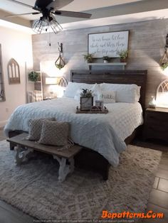 a bedroom with a bed, bench and ceiling fan