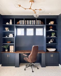 a home office with built in bookshelves, desk and chair on carpeted floor