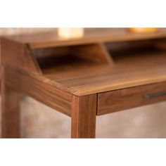 a close up of a wooden table with an open drawer on it's side