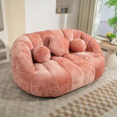 a living room filled with furniture and a large round couch in the middle of it