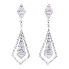 18 Karat White Gold 1.77 Carats Diamond Drop Earrings in Contemporary Style The glamourous earring has a really unique design making it an excellent piece that can be enjoyed often. The earring is amicably formed with two quadrilateral shapes filled with baguette-cut and brilliant-cut diamonds. The baguette-cut diamonds are set in close setting to give importance to the diamonds by reducing the visibility of the metal. It's a beautiful setting and the brilliant-cut cluster on the top and the bot Life Necessities, Quadrilateral Shapes, Art Deco Earrings Vintage, Diamond Earring, Baguette Cut Diamond, Diamond Drops, Baguette Cut, Girly Jewelry, Diamond Drop Earrings