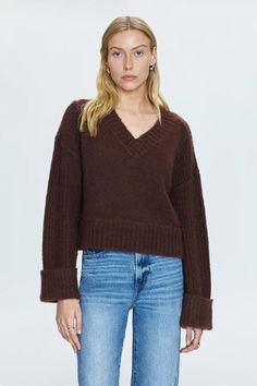 Textured, medium weight pullover sweater. Designed for boxy, relaxed silhouette with oversized cuffed sleeves, cropped length hem, and wide V open neckline. Oversized ribbing details at neckline, cuffs, and hem. Offered in a dark brown hue. Length : 20" 64% Acrylic | 13% Polyester | 9% Nylon | 8% Alpaca | 4% Wool | 2% Spandex Dry Clean Model is 5’9” wearing size Small Best Swimwear, Boxy Sweater, Knit Bottom, Textured Sweater, Football Tees, Dark Roast, Romper Pants, Cozy Sweaters, Cuff Sleeves