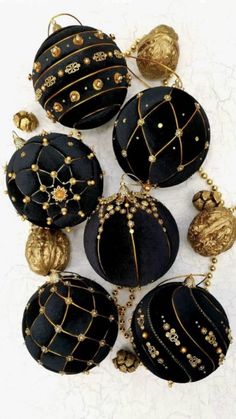 black and gold ornaments are arranged on a white surface