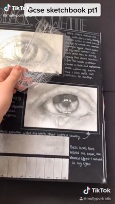 someone is drawing an eye on a piece of paper