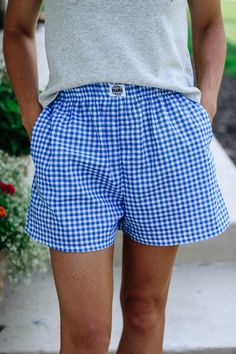 a person wearing blue and white checkered shorts