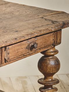 an old wooden table with two drawers on it